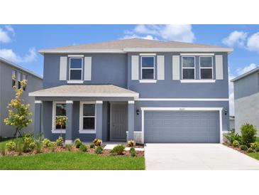 Charming two-story home with a two-car garage, landscaped yard, and a covered front porch at 16025 7Th E Ave, Bradenton, FL 34212