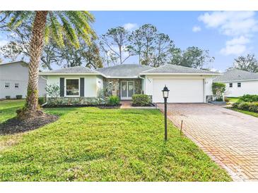 Single-story home with stone accents and a brick driveway at 2222 Westchester Blvd, Spring Hill, FL 34606