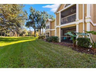 Ground level condo with a screened patio and grassy backyard at 9481 Highland Oak Dr # 512, Tampa, FL 33647