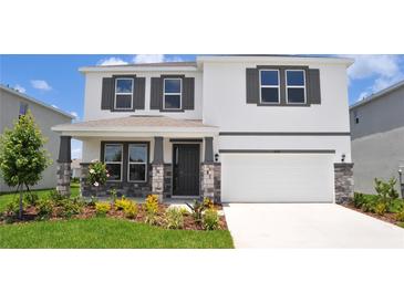 Charming two-story home with a well-manicured lawn and stylish stone accents on the front porch at 16017 7Th E Ave, Bradenton, FL 34212