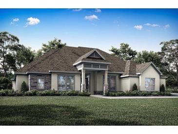 One-story home with stone accents and a three-car garage at 13400 Haflinger Way, Hudson, FL 34667