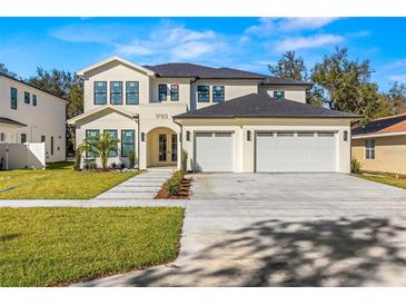 Two-story home with a three-car garage and landscaped front yard at 1703 Cedar St, Safety Harbor, FL 34695