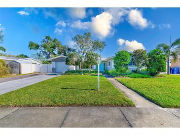 Single story home with a well-manicured lawn and driveway at 3201 61St N St, St Petersburg, FL 33710