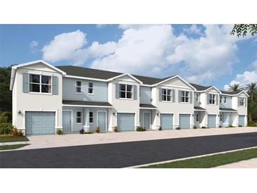 Five-unit townhome building with light blue exterior and attached garages at 4600 Stargazer Ct, Palm Harbor, FL 34683