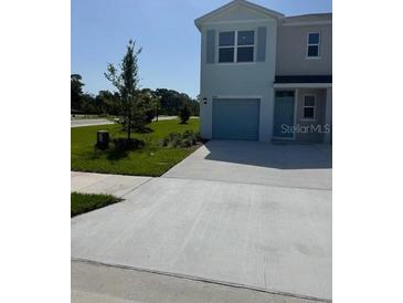 Inviting two-story home with a well-maintained lawn, private driveway, and attached garage at 4604 Pleasant Ave, Palm Harbor, FL 34683