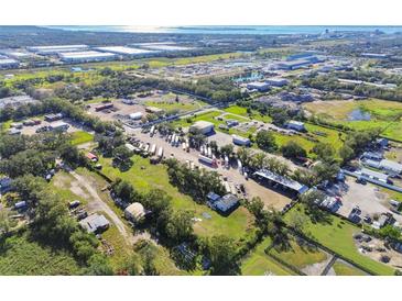 Aerial view of Tampa, FL property, showing surrounding businesses and land at 6106 Hartford St, Tampa, FL 33619