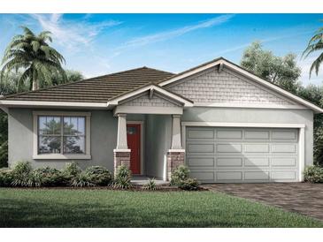 One-story home with gray siding, brown roof, and red door at 12211 Meditation Trl, Venice, FL 34293