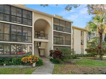 Two-story condo building with balconies and lush landscaping at 1398 Shady Pine Way # H2, Tarpon Springs, FL 34688