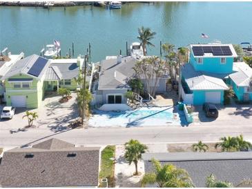 Aerial view of waterfront homes with boats and docks at 353 144Th Ave, Madeira Beach, FL 33708
