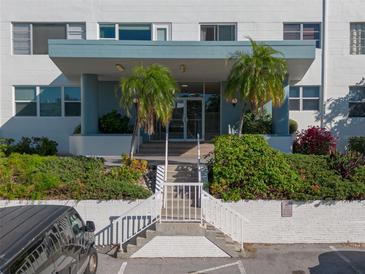 Condo building exterior featuring a modern design and lush landscaping at 55 Harbor View Ln # 301, Belleair Bluffs, FL 33770
