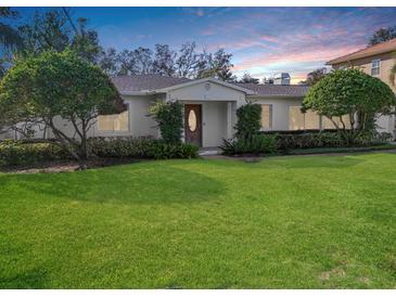 Charming single-story home with a well-manicured lawn and lush landscaping at 141 Miramar Ne Blvd, St Petersburg, FL 33704