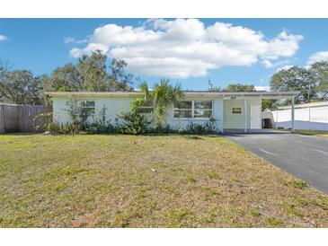 Charming single story home with well-manicured lawn and driveway at 1514 Nelson Ave, Clearwater, FL 33755