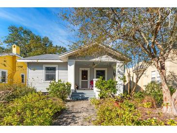 Charming bungalow with gray siding, covered porch, and landscaped yard at 2910 11Th N St, St Petersburg, FL 33704