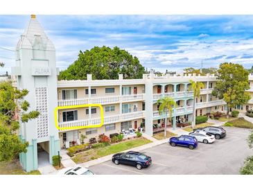 Building exterior showcasing a condo unit with a balcony and ample parking at 2330 Ecuadorian Way # 30, Clearwater, FL 33763