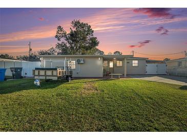 House exterior at dusk, featuring a well-manicured lawn and a driveway at 4522 W Knox St, Tampa, FL 33614