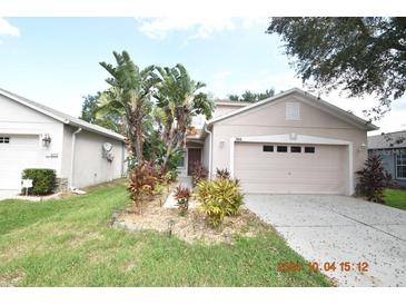 Two-story house with attached garage and landscaped front yard at 504 Maple Pointe Dr, Seffner, FL 33584