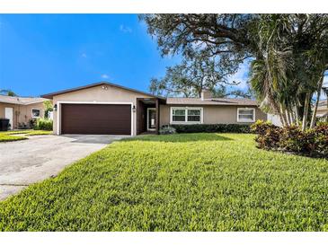 Charming ranch home with a well-manicured lawn and mature trees at 5857 25Th S St, St Petersburg, FL 33712