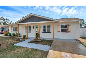 Renovated single story home with walkway and landscaping at 9126 109Th Ter, Seminole, FL 33777