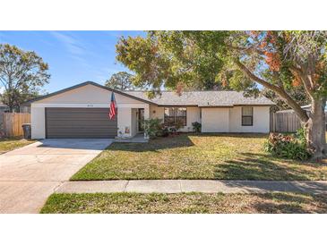 Charming single-story home with a well-maintained lawn and attached garage at 652 Timber Bay W Cir, Oldsmar, FL 34677