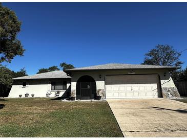 Ranch style home with attached garage and well-maintained lawn at 11253 Leland St, Spring Hill, FL 34609