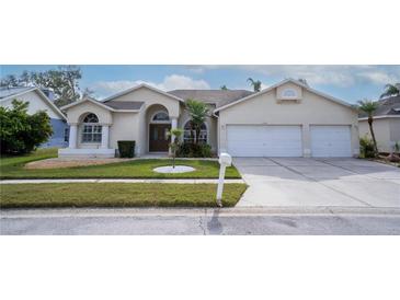 Beautiful two-story home with a three-car garage and manicured lawn at 12922 Prestwick Dr, Riverview, FL 33579