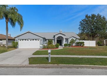 Single-story home with attached garage and landscaped yard at 22921 Sterling Manor Loop, Lutz, FL 33549