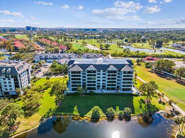 Aerial view of a condo building with golf course and water views at 14810 Rue De Bayonne # 7F, Clearwater, FL 33762