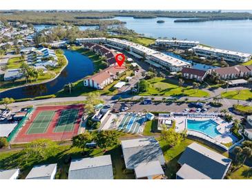 Aerial view of condo community showing location, pool, and tennis court at 4859 Independence Dr, Bradenton, FL 34210