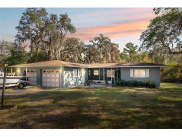 Ranch style home with attached garage and boat at 5255 Azalea Cir, Dade City, FL 33523