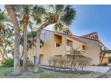 Attractive multi-story home with a blue front door, palm trees, and a two-car garage at 1630 Royal Palm S Dr # A, St Petersburg, FL 33707