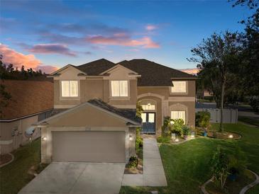 Two-story house with a large yard, double garage, and walkway at 19301 Sandy Springs Cir, Lutz, FL 33558