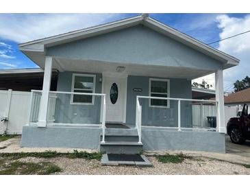 Newly painted light blue house with white trim and a modern glass railing at 2907 W Palmetto St, Tampa, FL 33607