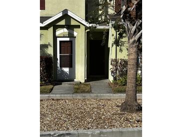 Front exterior of a two-story home with a brown door and green siding at 6023 Osprey Lake Cir, Riverview, FL 33578