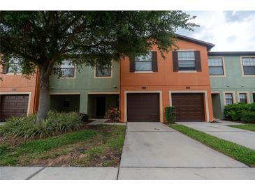 Two-story townhome with attached garage and landscaped front yard at 2633 Edgewater Falls Dr, Brandon, FL 33511