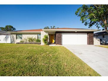 Updated single story home with stone exterior and a two-car garage at 2766 Brattle Ln, Clearwater, FL 33761