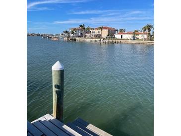 Stunning waterfront view of canal with boats and upscale homes at 569 Boca Ciega Point N Blvd # 2602, St Petersburg, FL 33708