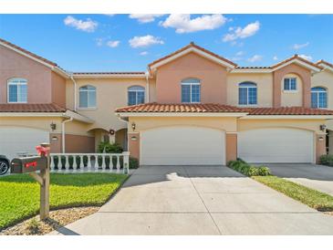 Attractive townhome exterior with landscaping and a two-car garage at 6321 Vista Verde E Dr, St Petersburg, FL 33707