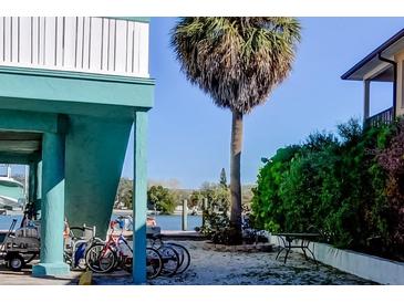 Waterfront property with lush tropical landscaping, boat dock, and outdoor space at 141 94Th Ave, Treasure Island, FL 33706