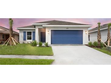 One-story home with blue garage door and landscaping at 479 Winwood Ct, Port Charlotte, FL 33954