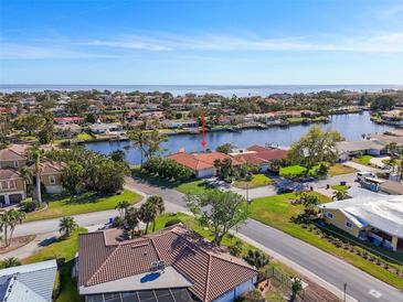 Aerial view of waterfront home with canal access and lush landscaping at 1998 Massachusetts Ne Ave, St Petersburg, FL 33703