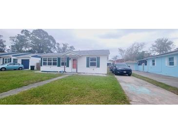 Cute bungalow-style home with a well-manicured lawn and driveway at 2800 47Th S St, Gulfport, FL 33711