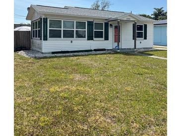 Charming home with white siding, green shutters, and a well-maintained front yard at 2800 47Th S St, Gulfport, FL 33711