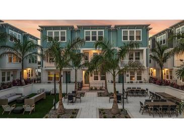 Townhome exterior featuring an outdoor seating area with tables, chairs and grill; ideal for gatherings at 3109 4Th N Ter, St Petersburg, FL 33713