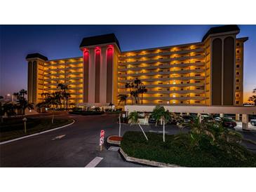 Night view of a condo building with parking and landscaping at 4750 Cove Cir # 307, St Petersburg, FL 33708