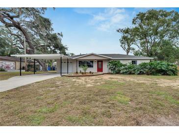 Newly renovated home with carport and landscaped yard at 105 Phillips Dr, Seffner, FL 33584