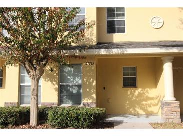 Inviting exterior of a two-story townhome with attractive landscaping at 37715 Aaralyn Rd, Zephyrhills, FL 33542