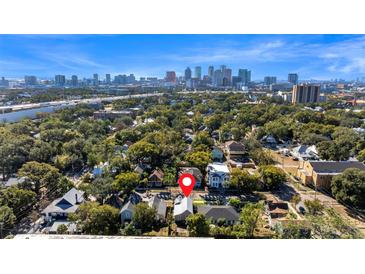 Stunning aerial view of the city skyline, tree-lined neighborhood and home's location at 408 E Amelia Ave, Tampa, FL 33602
