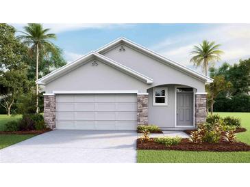 One-story home with gray siding, stone accents, and a two-car garage at 7065 Broad River Ave, Land O Lakes, FL 34638