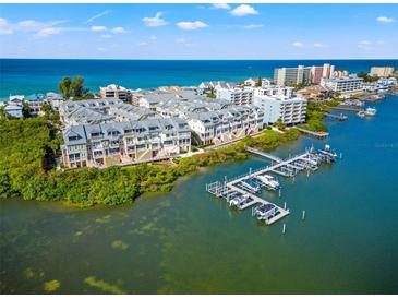 Aerial view of waterfront community with boat slips and ocean access at 19915 Gulf Blvd # 805, Indian Shores, FL 33785