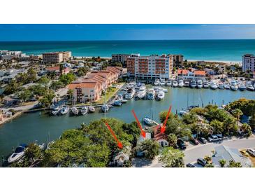 Aerial view of waterfront property, showing a house and marina at 249 Boca Ciega Dr, Madeira Beach, FL 33708